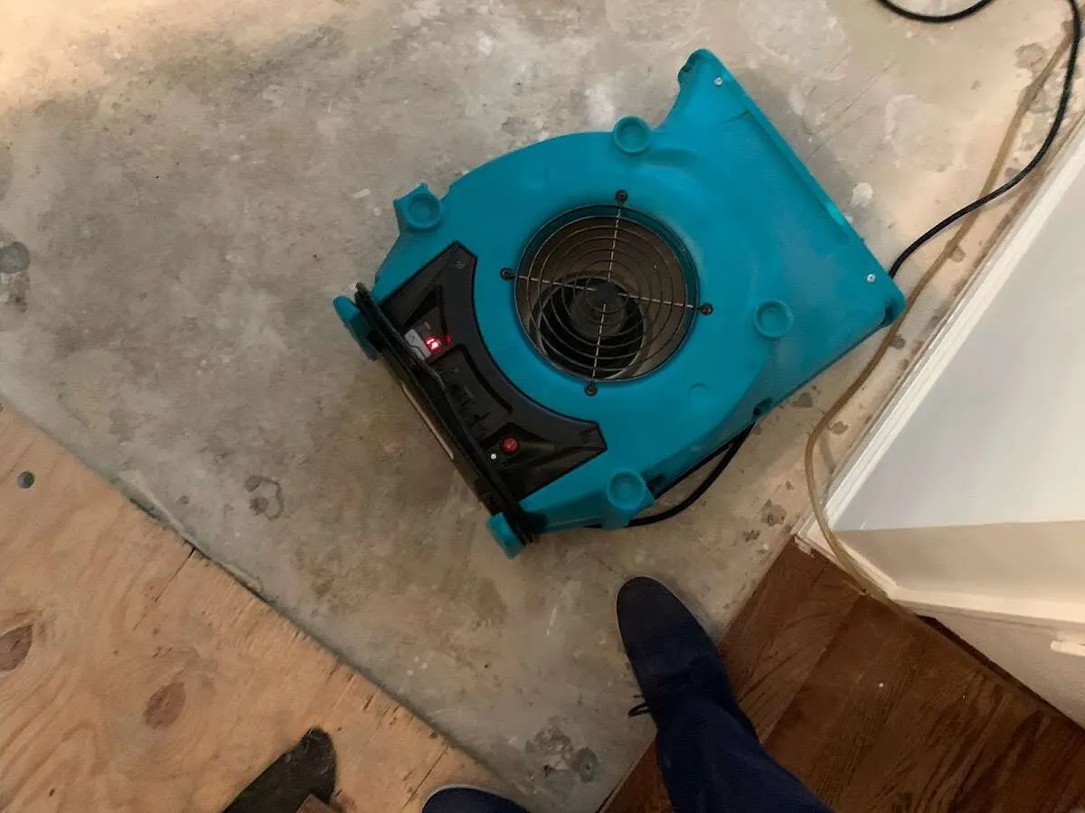 Air mover drying subfloor during Commercial Water Damage Restoration in Madera Ranchos